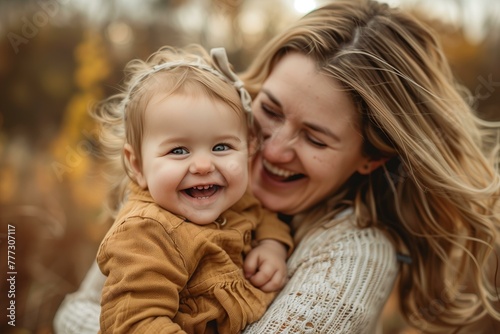 close up portrait mother holding a toddler, both laughing, casual clothes, candid, Mother's Day