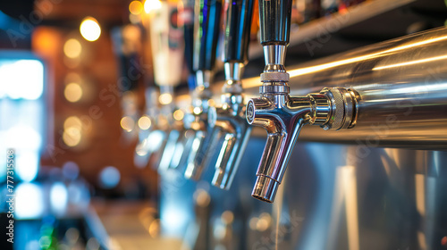 Row of stainless steel beer taps at a modern bar, with focus on the intricate details and craftsmanship.