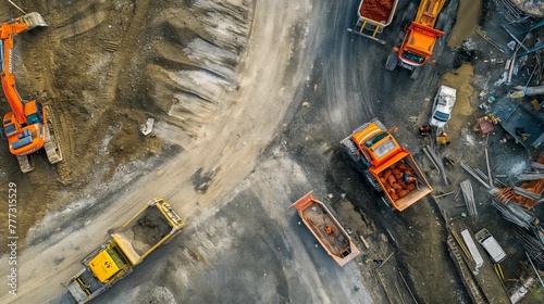 Top-down shot of an urban renewal project featuring earthmovers and dump trucks amidst freshly laid concrete.