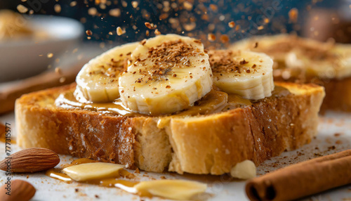 Toasted bread with almond butter spread, banana slices, sprinkle of cinnamon. Tasty breakfast. © hardvicore