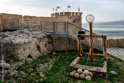 Ancient medieval catapult replica and cannon balls at the Golubac fortress in Serbia. Europe. photo