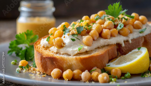 Close-up of toasted bread with chickpeas mixed with vegan mayo, lemon juice, and chopped fresh herbs