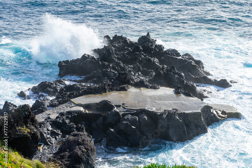 Powerful waves crash along the shoreline of Cinco Ribeiras, a scenic bathing area on Terceira Island, Azores.