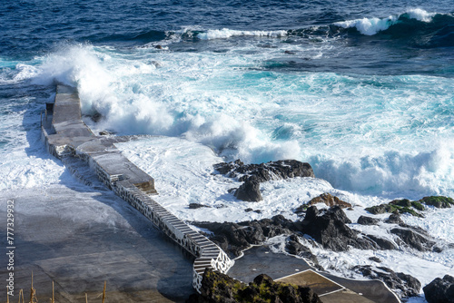 Powerful waves crash along the shoreline of Cinco Ribeiras, a scenic bathing area on Terceira Island, Azores.