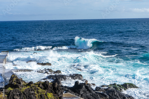 Powerful waves crash along the shoreline of Cinco Ribeiras, a scenic bathing area on Terceira Island, Azores.