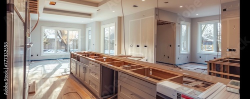 An incomplete kitchen installation new cabinetry and countertops, with protective coverings and tools sign of ongoing work