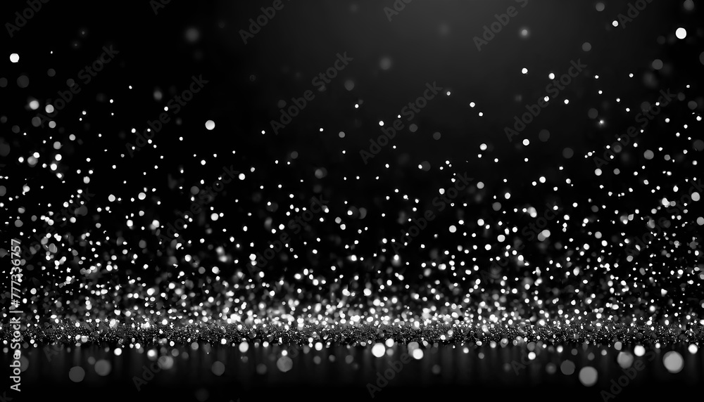 White bokeh particles on a black background