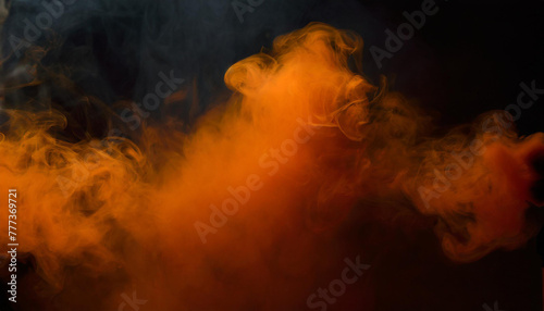 Orange smoke in the dark. Isolated on black background.