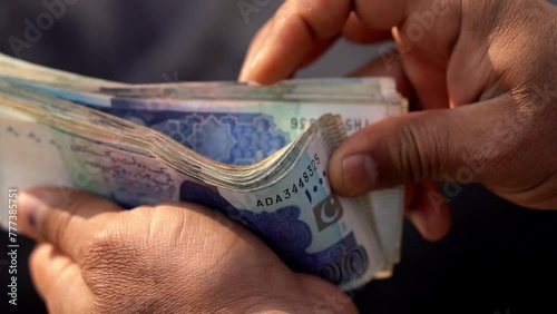 Man hand closeup Counting pakistani currency notes, business and property dealing in cash