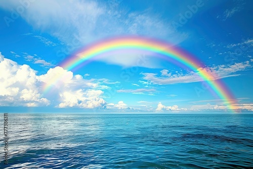 A rainbow arching over the ocean symbolizes hope and joy. © MSTSANTA