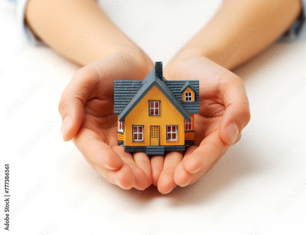 Palms cradling a colorful toy house on a white backdrop. Real estate investment concept. Generative AI Palms cradling a colorful toy house on a white backdrop. Real estate investment concept. Generative AI