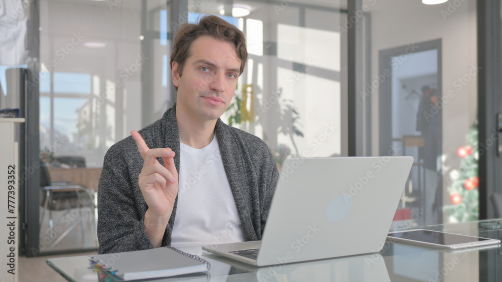 Fototapeta premium Young Man in Denial while Working in Office