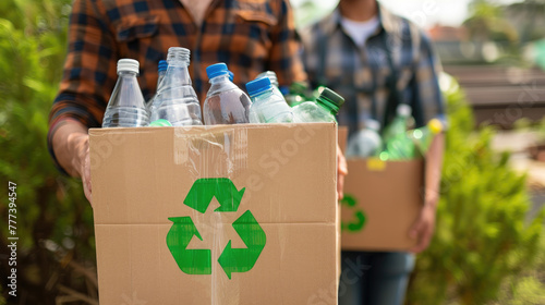 Sorting garbage. Plastic bottles in a cardboard box.