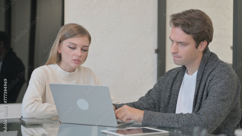 Young Couple Working on Computer in Office