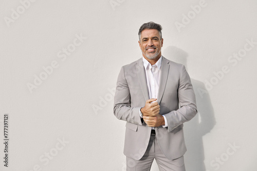 Confident elegant middle aged business man entrepreneur, smiling mature professional executive, stylish businessman leader wearing suit looking at camera stands isolated on white background, portrait.