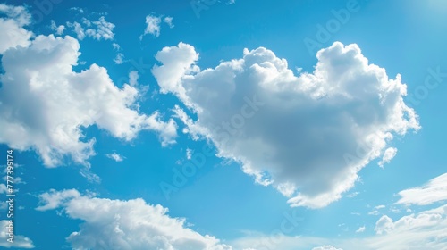 Heart-shaped cloud in blue sky. Nature photography with copy space.