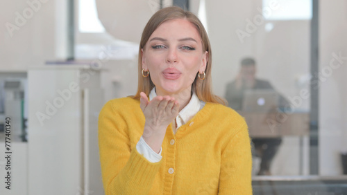 Portrait of Young Woman Blowing a Kiss in Love