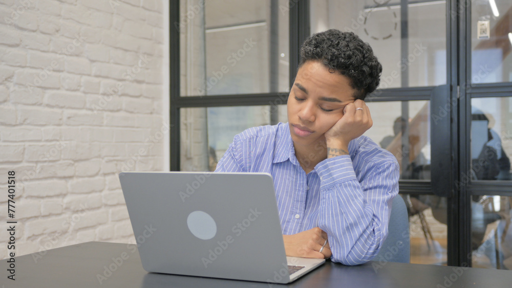 Tired Young African Woman Sleeping in Front of Laptop