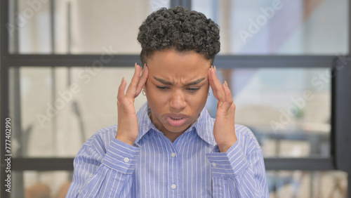 Portrait of African Woman with Headache in Office