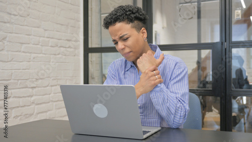 Young African Woman having Wrist Pain in Office