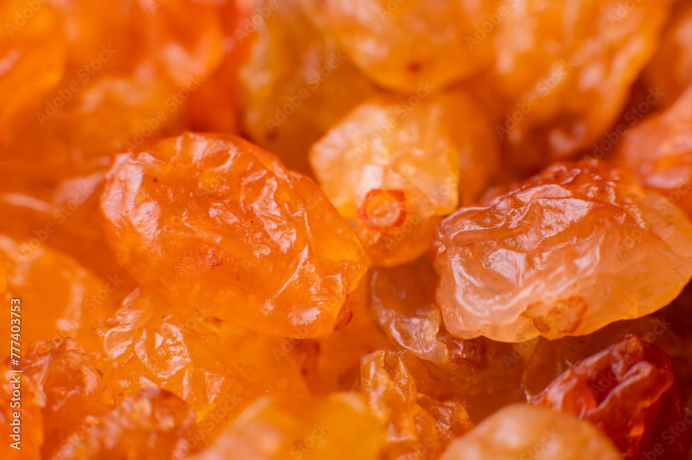 Background of a large number of dried yellow golden grapes. Raisin. Vegetarian diet Background of a large number of dried yellow golden grapes. Raisin. Vegetarian diet