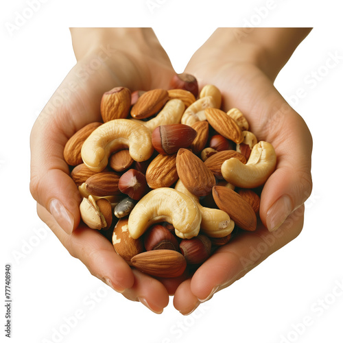 A hand is holding a handful of nuts, including almonds, cashews, and walnuts