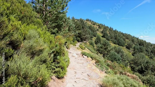 Hiking along a path towards the famous Laguna Grande de Penalara, in a forest of Sierra de Guadarrama, Madrid, Spain. Point Of View (POV), subjective view
 photo