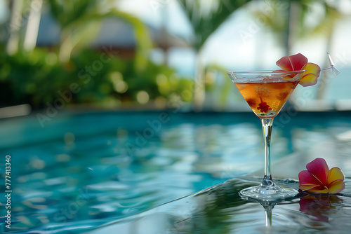 A refreshing cocktail rests on the edge of a sparkling pool, offering a tantalizing sip of luxury relaxation © River Girl