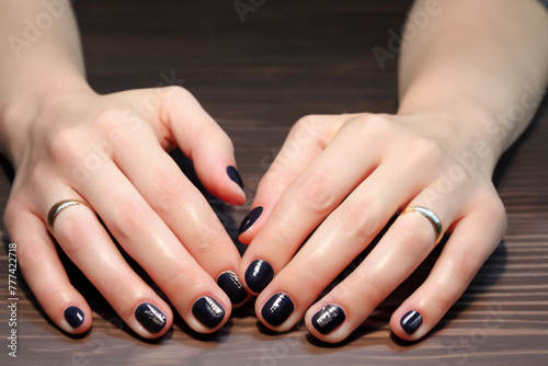 black manicure classic black manicure on short nails of a female hand with silver rings  close-up  beauty concept