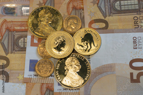 Gold coins with the EURO banknotes in background.	 photo