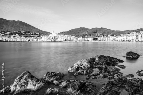 Long exposure landscape of Cadaques seaside village shoreline in Catalonia, Spain on the Mediterranean Sea riviera in black and white