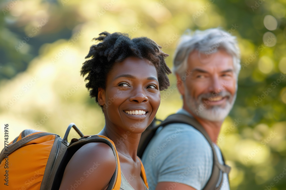 Middle aged multiracial married couple or friends hiking outdoors Middle aged multiracial married couple or friends hiking outdoors