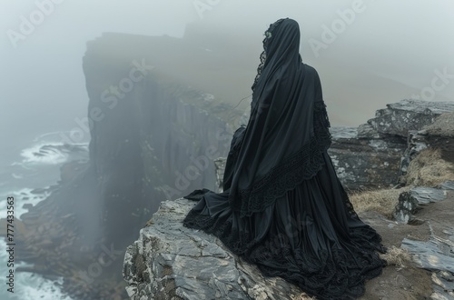 A mysterious, veiled figure in black standing on cliffs overlooking the stormy sea, evoking solitude and contemplation © Nena Ai