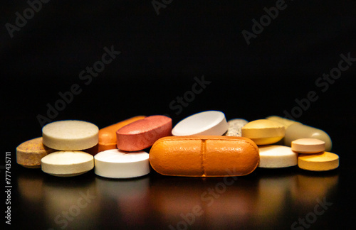 close up with different pills on a black background