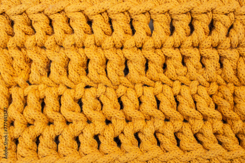 Orange cotton cord crochet pattern, abstract texture background, soft focus close up
