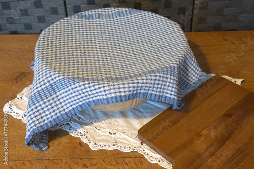 Traditional  mixing  bowl  with  blue and  white cloth  covering   it  traditional  baking 