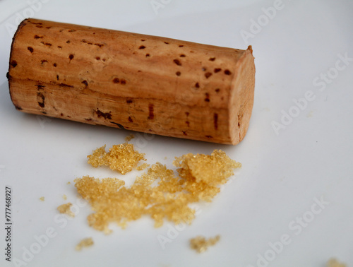 white wine crystals  and a wine cork on a white background photo