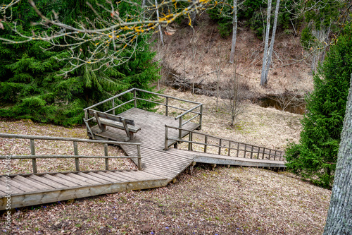 High wooden staircase leading to a picnic area. Vilce Nature Park, Latvia. Wooden stairway with viewing platform. photo