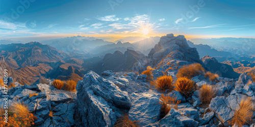 The sun shines on the top of mountain, overlooking a wide view of mountains and valleys below.sunset in the mountains, sunrise in the mountains © Planetz