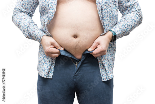 Overweight man with fat belly trying to fasten tight trousers, isolated on white background photo