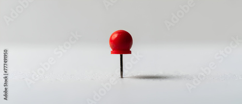 A colorful thumb tack against a white background ,Macro shot of a red pushpin isolated on a white background
