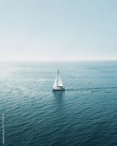 A solitary sailboat on a vast ocean, offering a minimalist and expansive summer seascape for clean design layouts photo