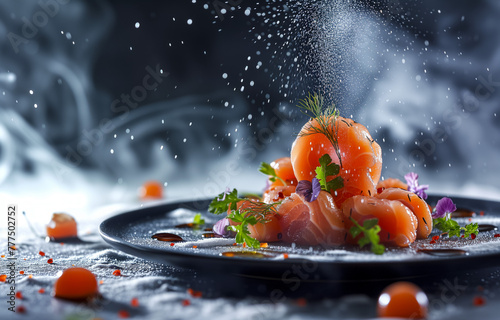 Sliced salmon sashimi with dill and edible flowers on dark plate
