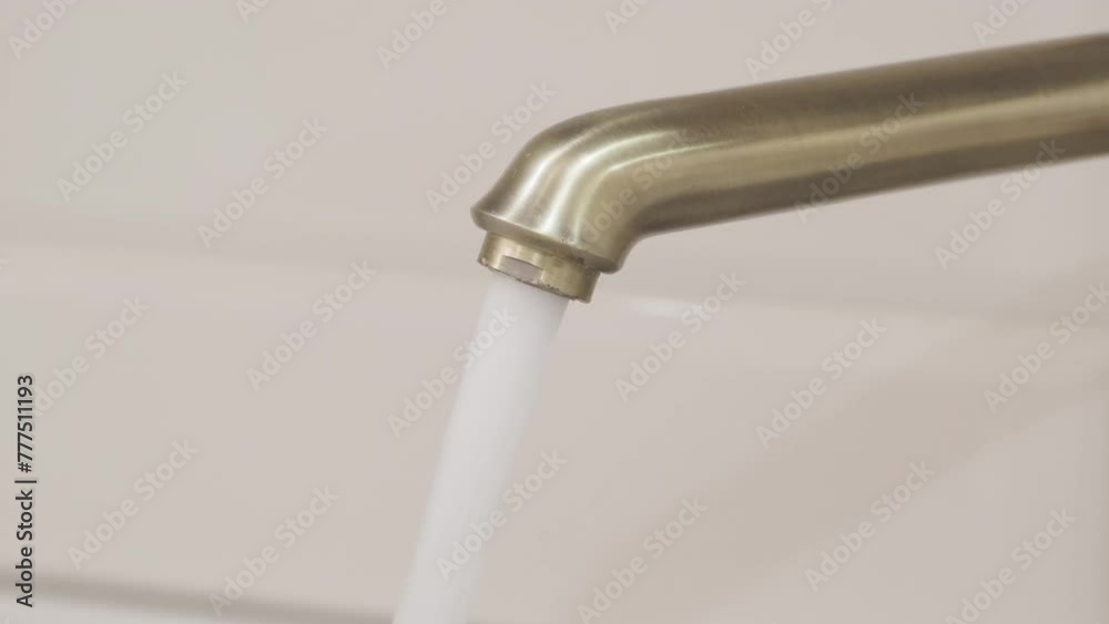 water starts pouring out of tap in rapid stream, close-up, slow motion, selective focus
water starts pouring out of tap in rapid stream, close-up, slow motion, selective focus