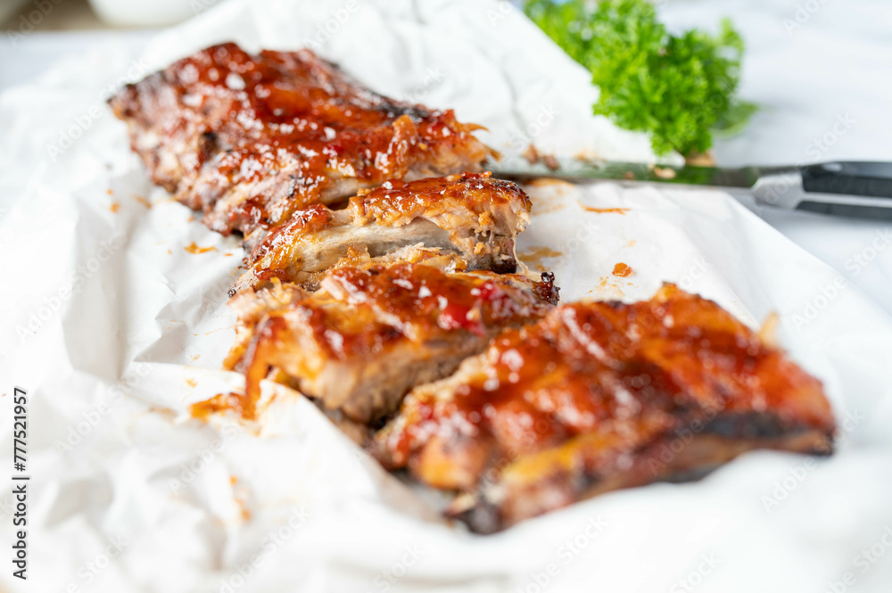 Fresh barbecue honey glazed pork ribs or spareribs on light background Fresh barbecue honey glazed pork ribs or spareribs on light background
