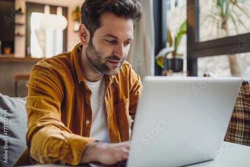 lively american man in his 30s, intently focusing on her laptop screen with an optimistic and determined look