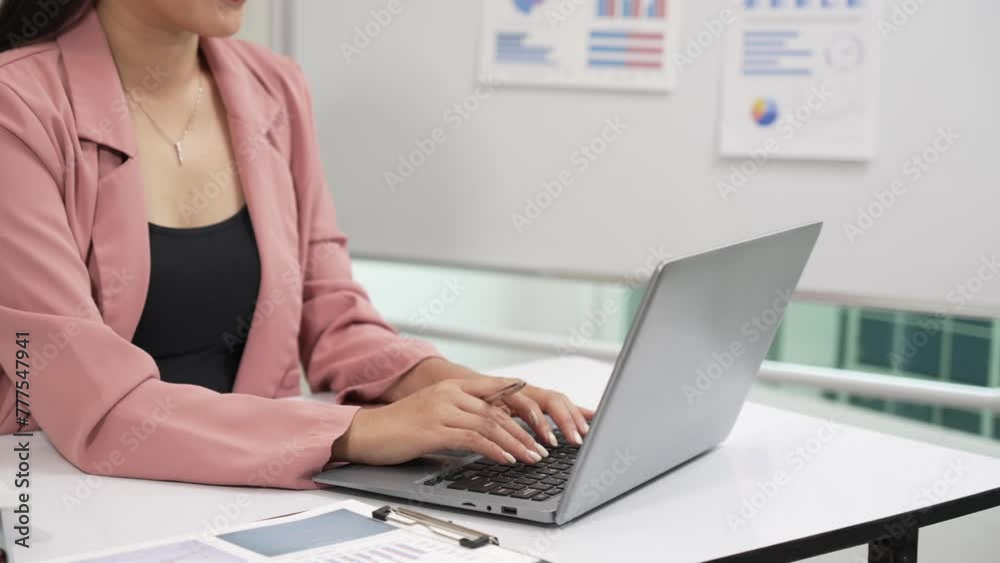 Young Asian accountant working with financial graph documents and using calculator to calculate savings or copying on laptop and taxes, trading, research, accounting document, company 4k Young Asian accountant working with financial graph documents and using calculator to calculate savings or copying on laptop and taxes, trading, research, accounting document, company 4k