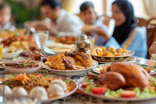 A large table is covered with a variety of food, including chicken, potatoes