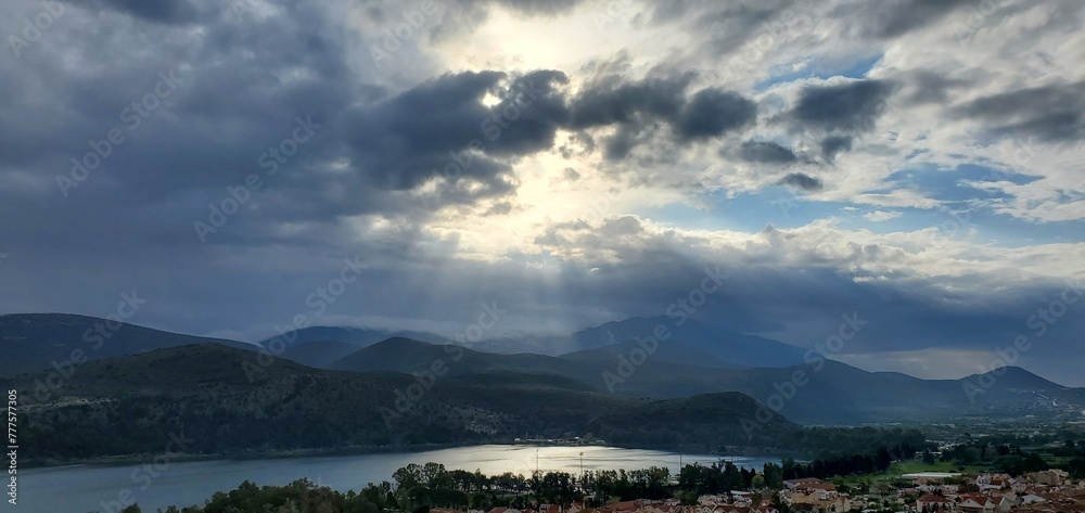 Sun peaking through the clouds over Argostoli, Greece
