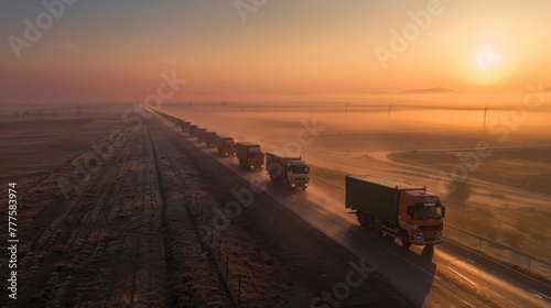 Aid convoy of trucks on a mission at dawn heading through a misty landscape